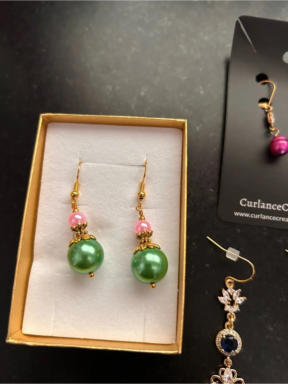 7 pair pierced earrings, drop style, most never worn, gold tone metals.